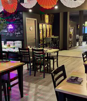 a restaurant with tables and umbrellas and umbrellas