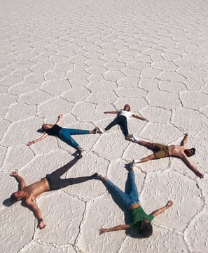 Photo on the Uyuni Salt Flat where we form a star shape with our bodies.