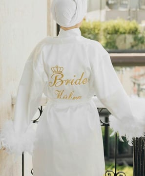 a bridesmaid wearing a white robe