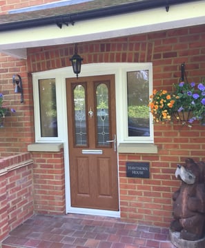 oak wood colour composite door with decorative glass and half glazed side panels 
