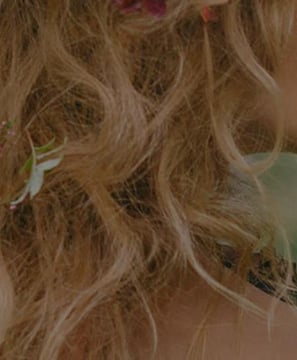 a woman with long hair and flowers in her hair