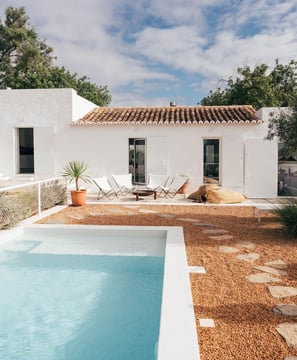 Swimming pool in the back yard of a white house in Portuguese countryside