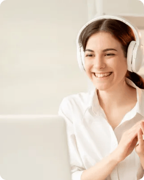 Woman using a laptop wearing headphones