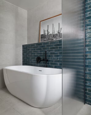deep, glossy teal metro tiles, laid in a horizontal stack with white grout and fluted shower screen