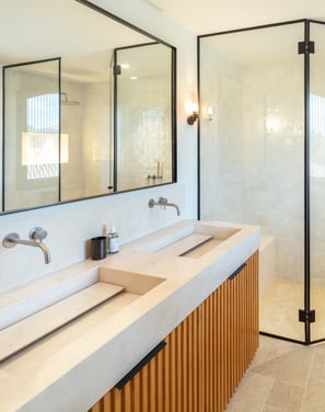Modern bathroom with double vanity, walk-in rain shower, and natural light at Villa La Gratitud.