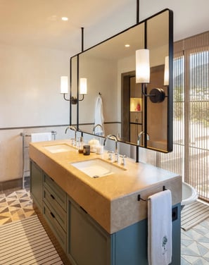 Elegant bathroom at Villa La Gratitud with double vanity, designer lighting, and mountain views.