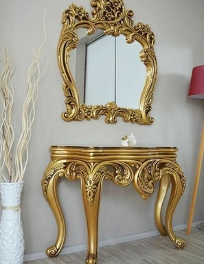 A luxury gold console table with gold mirror 