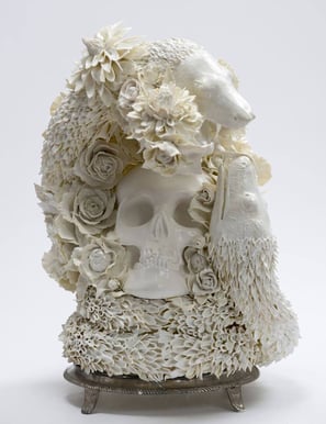 sculptur a skull head with a skull and flowers on it