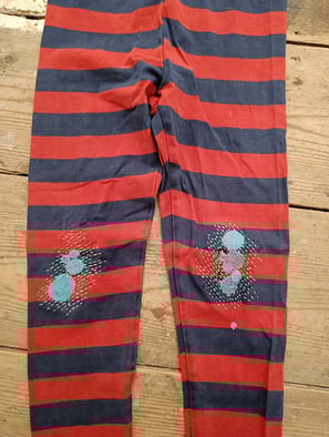 Visible mending to knees of trousers 