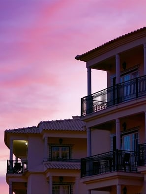 Building with balconies under the beautiful pink sunset