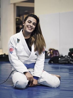 Remi White, smiling on the mat
