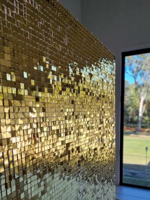 Gold shimmer wall setup in the lounge looking out the the yard for Maria's 60th in Brisbane.