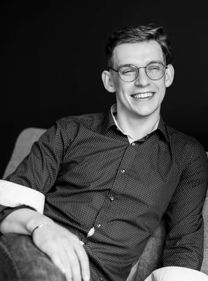 a man sitting on a couch with a cup of coffee