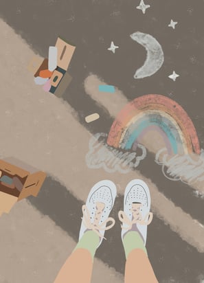 a person standing on a sidewalk with a rainbow painted on the sidewalk