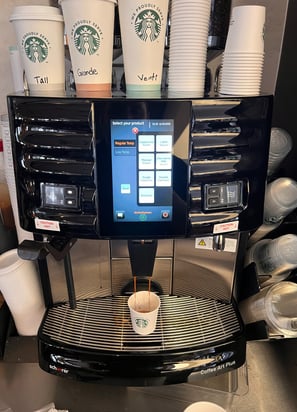 Schaerer Coffee Art Plus espresso machine dispensing coffee at a Starbucks location.
