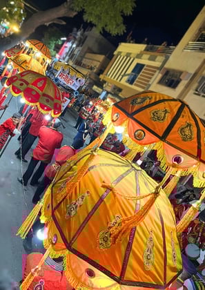 Gangaur roadshow featuring the Manohar Brass Band with a light show at night.