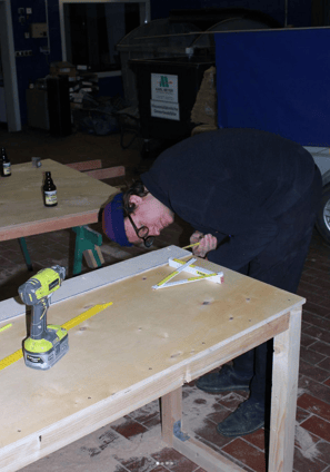 a man is working on a table with a tool
