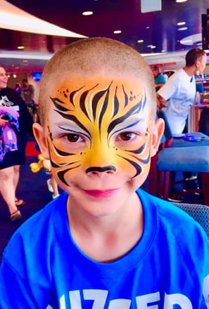 Boy Tiger Face Painting at a Large Event