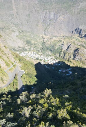 a mountain view of a valley with a winding road