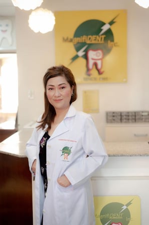 a woman in a lab coat standing in front of a counter