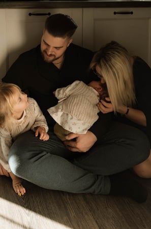 Familie am Küchenboden mit Baby lacht Neugeborenen Foto Wiener Neustadt Sophie Sara Fotografie