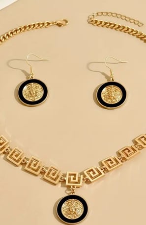 a necklace and earrings set with a gold chain link necklace