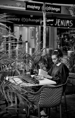 The lens of Peter Pickering does not interrupt the girls reading of her book