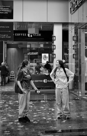 Two friends happily sharing a story caught by the lens of Peter Pickering