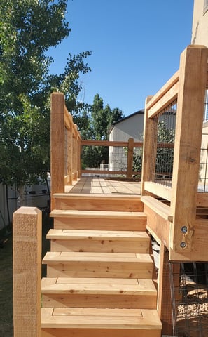a wooden deck with a wooden deck and stairs