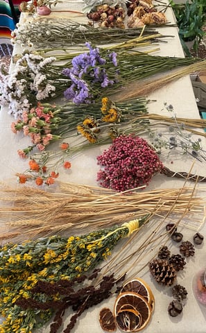 a table with a bunch of dried flowers