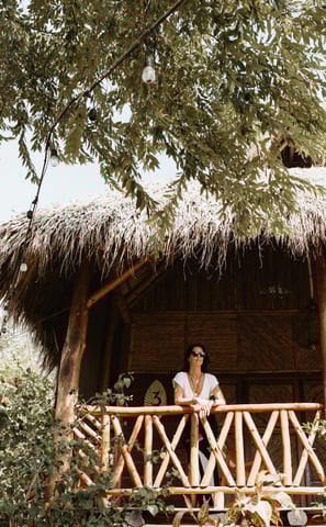woman on her balcony overlooking the tropical garden