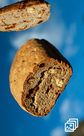 a piece of bread flying with a slice of bread the top of it