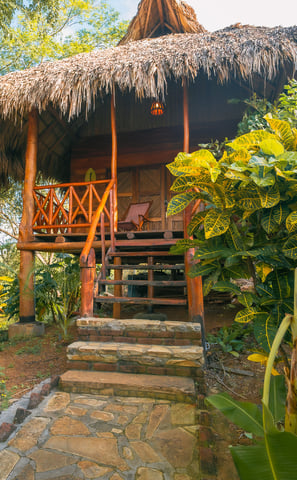 wooden bungalow in tropical garden