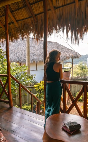 woman on her balcony overlooking the ocean