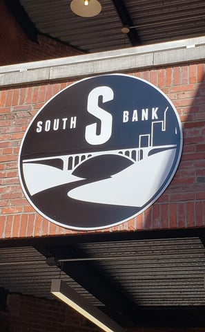 Aluminum Composite Sign with full color digital graphics installed on the brick face of an apartment complex