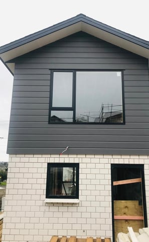 a house with a large window and a wooden table