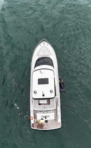 a boat with a man standing on the water