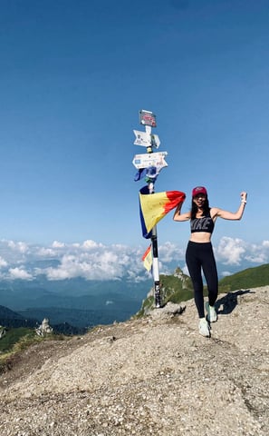 a woman standing on top of a mountain