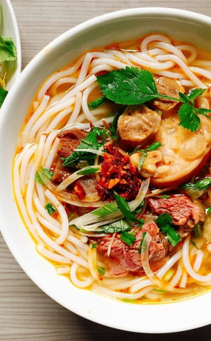 Ramen birria noodles topped with a flavorful garnishing.