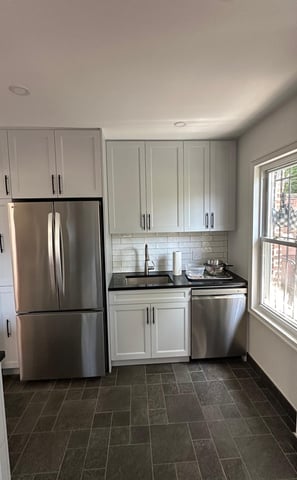 a kitchen with a refrigerator, stove, and refrigerator