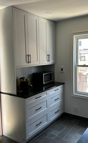 a kitchen with a microwave, microwave, and a microwave