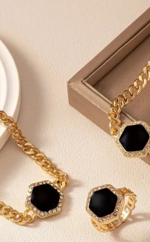 a necklace and earrings set with a black and white necklace