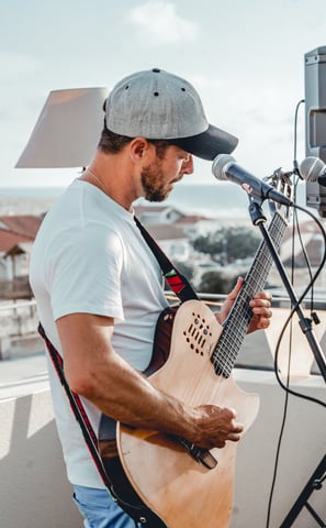 a man with a guitar and a microphone