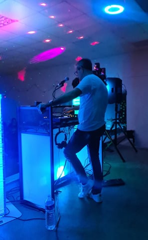 a man playing a keyboard in a room with a microphone and a keyboard