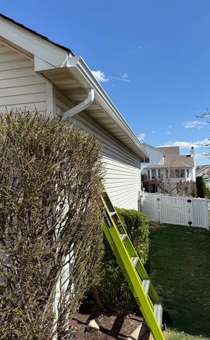 fiberglass ladder used to reach downspout