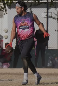 a woman in a purple shirt and a baseball glove