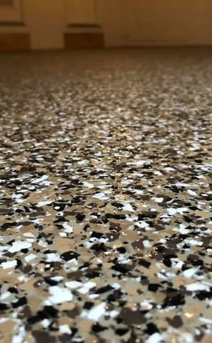 Epoxy garage floor in Lincoln home- Brown, white, and black epoxy flakes 