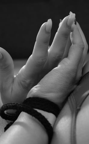 Close up of a woman's hands tied together