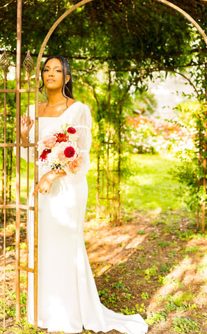 a woman in a white dress and a bouquet of flowers