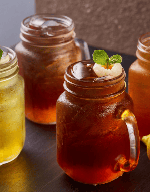 a variety of drinks in mason jars with lemonade